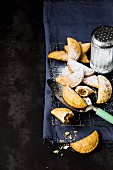 Warm deep fried apple pastries with icing sugar