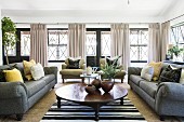 Classic living room in natural shades with bank of large windows