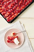 Strawberry cake on a baking sheet and a plate