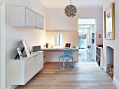 Fitted desk, wall-mounted cupboards and fireplace in study