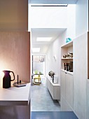 Open doorway next to desk with view of fitted furnishings and kitchen