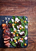 Marinated duck breast with a colourful spinach salad
