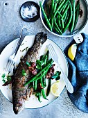 Rainbow trout with almonds, bacon and green beans