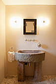 Old sandstone sink in cream bathroom