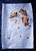 Remains of chocolate with almonds, sea salt, and roasted millet on baking paper