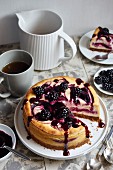 A small blackberry cheesecake, sliced