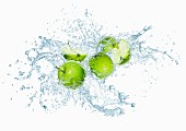 Green apples with water splash
