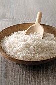 Sea salt in a wooden bowl with a scoop