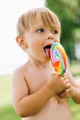Boy licking lollipop