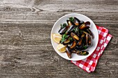 Mussels Clams and lemon on wooden background