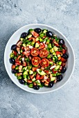 Turkish salad made with chopped cucumbers, tomatoes, onion and green pepper, spiced with sumac and red pepper flakes
