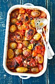 Chicken thights baked with potatoes, tomatoes and thyme