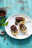 Mango and coconut popsicles with chocolate sauce