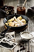 Kaiserschmarrn (shredded pancakes) with icing sugar and plums