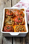 Gemista, tomatoes and yellow bell peppers stuffed with rice and herbs in tomato sauce