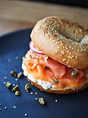 A bagel with salmon, cream cheese, capers and onion