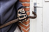 Burglar using a crowbar on a door