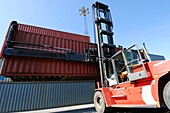 Forklift truck lifting shipping container