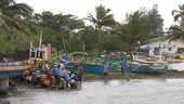 People pushing boat in Typhoon Noul