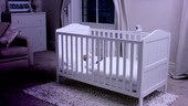 Baby asleep in cot