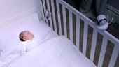 Baby in cot with monitor