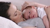 Baby lying on mother's chest