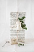 Vintage bell hung on gift wrapped in book pages