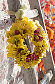 Wreath of Euonymus europaeus yellow autumn leaves and fruit sheaths