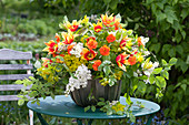 Lush arrangement with tulipa (tulip), geum (clove), syringa