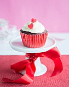 A cupcake with a red sugar heart