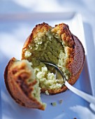 A pistachio muffin with a spoon