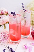 Gin and tonic with blackberry syrup and lavender blossoms
