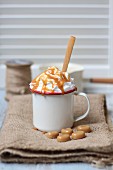A hot caramel drink topped with cream