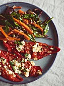 Caramelized carrots with mixed leaves with toasted pine nuts and stuff sweet peppers with feta