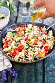Pasta salad with orzo, tomatoes, cucumbers and olives (Greece)