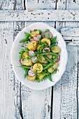 Potato salad with green beans, peas and radishes
