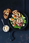 Chicken salad with boiled eggs and grilled bread