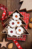 Christmas biscuits with red and yellow jam in a tree shaped box