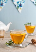 Lemon and rosemary tea in teacups