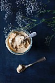Caramel ice cream in a glass with a spoon