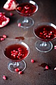 Pomegranate liqueur with pomegranate seeds in cocktail glasses