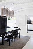 Table and chairs in the dining room with white wooden ceiling