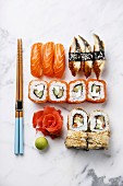 Sushi Set nigiri and sushi rolls on white marble background