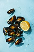 Mussels and lemon on blue background
