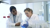 Scientists examining flask