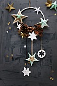 Christmas arrangement of stars and pine cones on ring