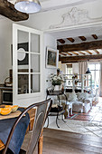 View from kitchen into lounge area with white loose-covered sofa