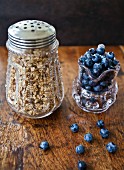 Granola in an antique jar and wild blueberries in a glass jar