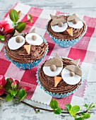 Cupcakes with chocolate cream and owl faces