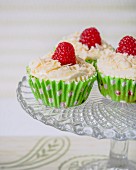 Cupcakes with white chocolate frosting and raspberries
